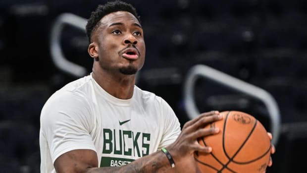 Bucks forward Thanasis Antetokounmpo shoots a ball during warmups before a game.